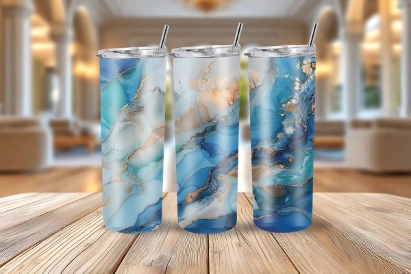 Drei Thermobecher mit einem abstrakten Ozean-Design in Blau-, Türkis- und Goldtönen, stilvoll nebeneinander auf einem rustikalen Holztisch vor einem luxuriösen Innenraum präsentiert.